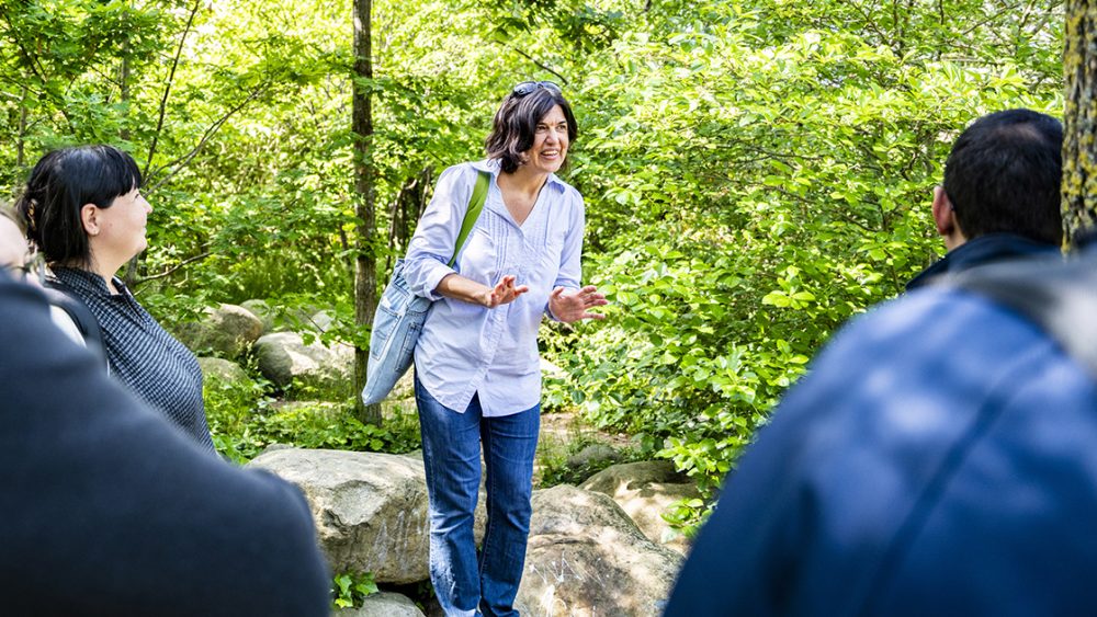 Bernadett Kiss lecturing in a small urban forest.