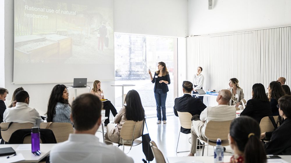 A woman presenting her group's change project